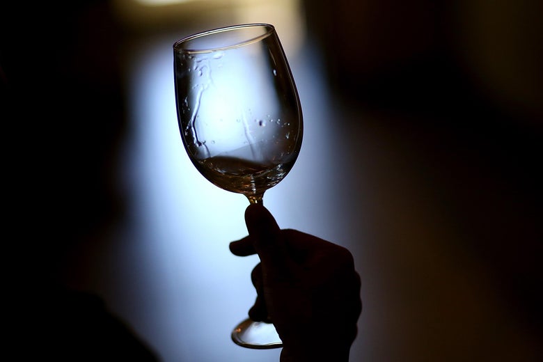 A visitor holds a glass of wine while tasting at Madonna Estate Winery.